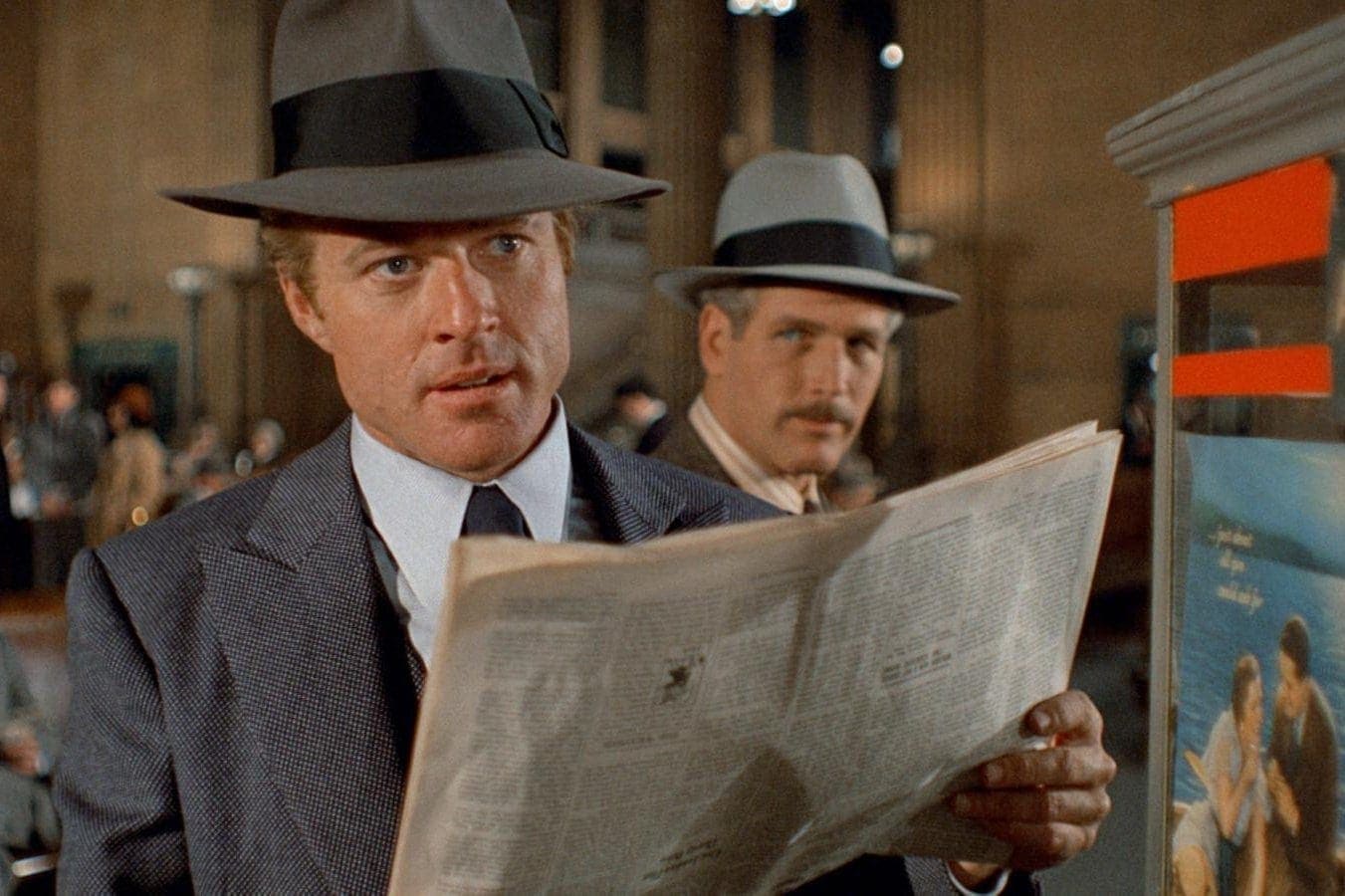 Robert Redford and Paul Newman in grey suits and hats in the 1973 movie “The Sting"