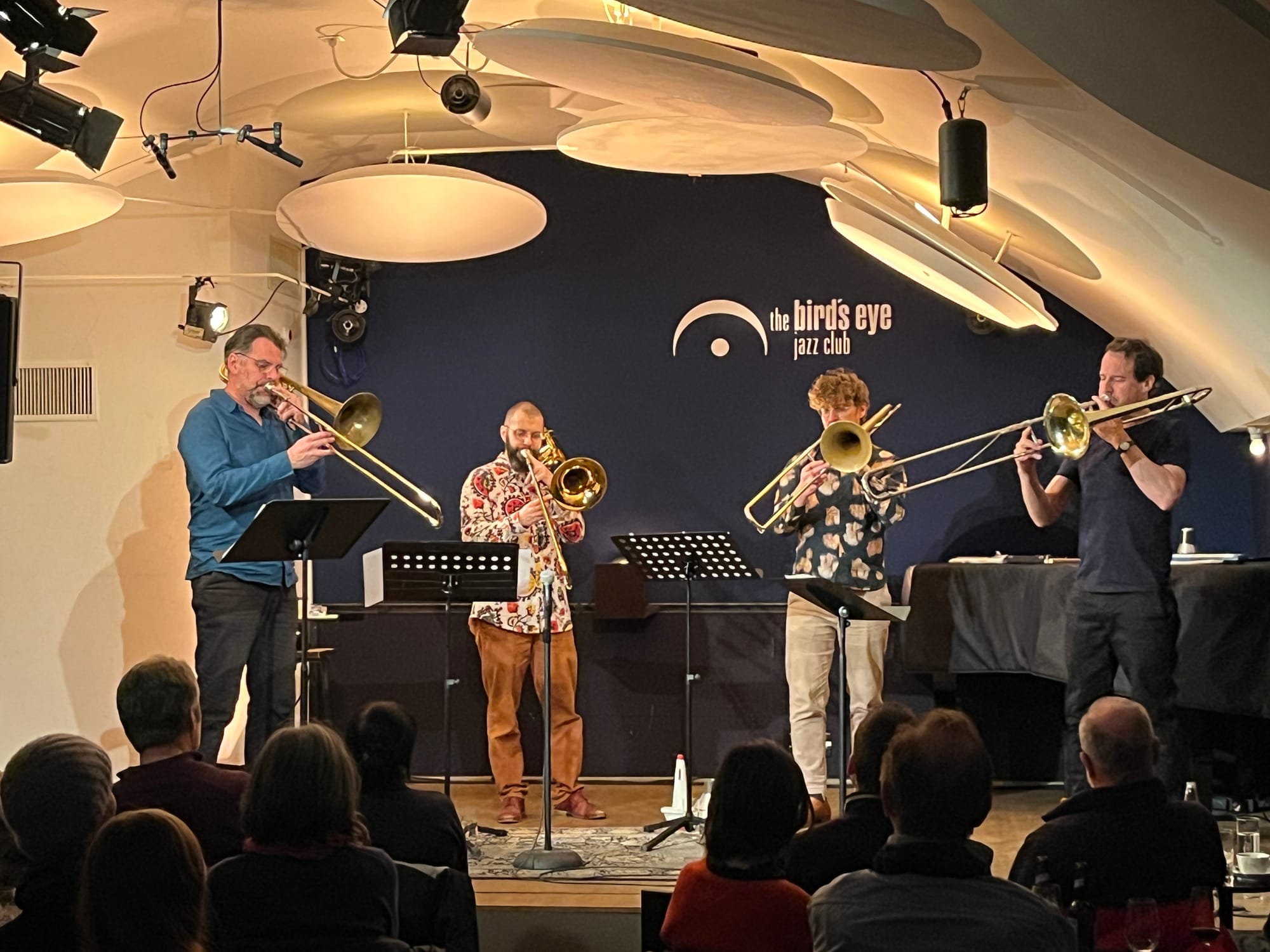 Four trombonists onstage at the Bird’s Eye Jazz Club.